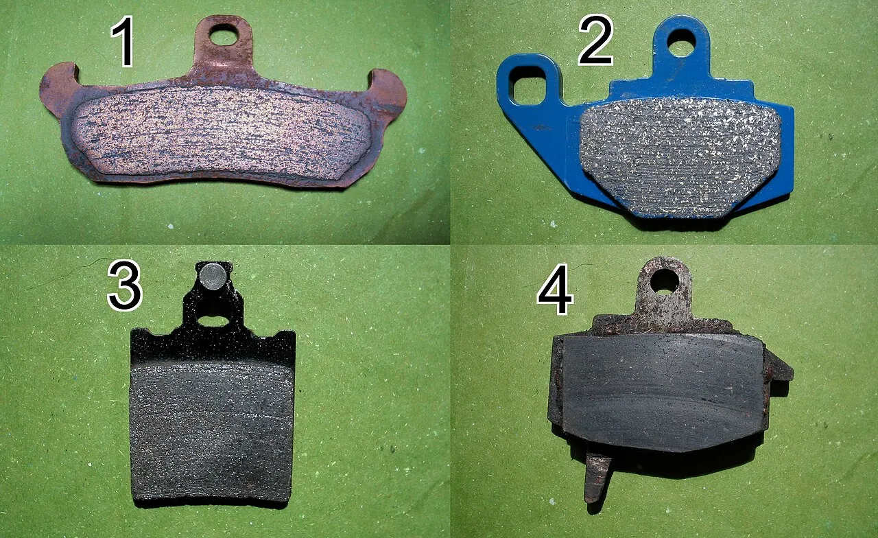 Worn brake pads being replaced during a mobile brake service in San Antonio